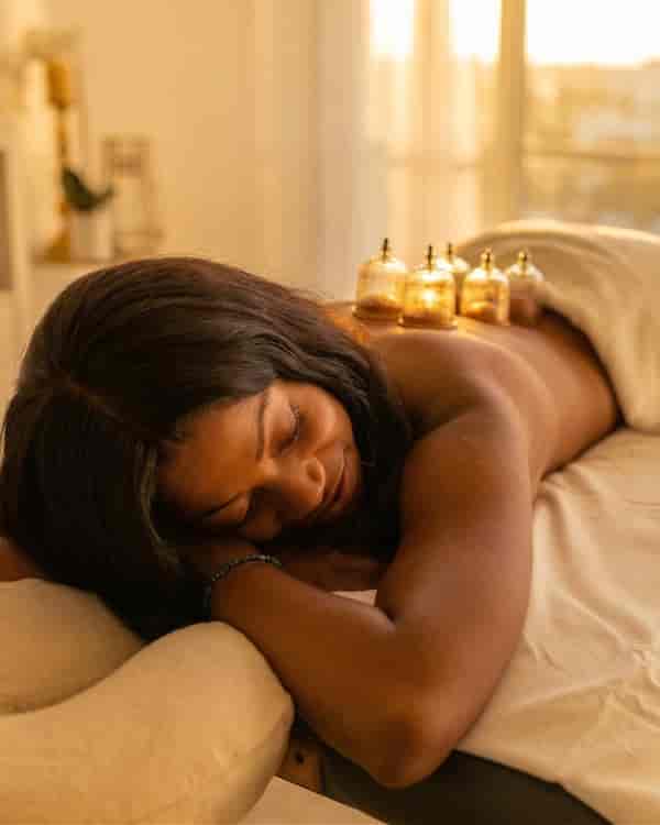 A therapist performing a spa massage treatment at Limban Resort's forest spa.
