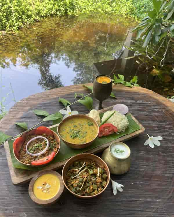 A beautifully set dinner table in a secluded forest location at Limban Resort.